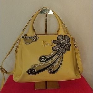 Tahari satchel embellished with shoulder strap.